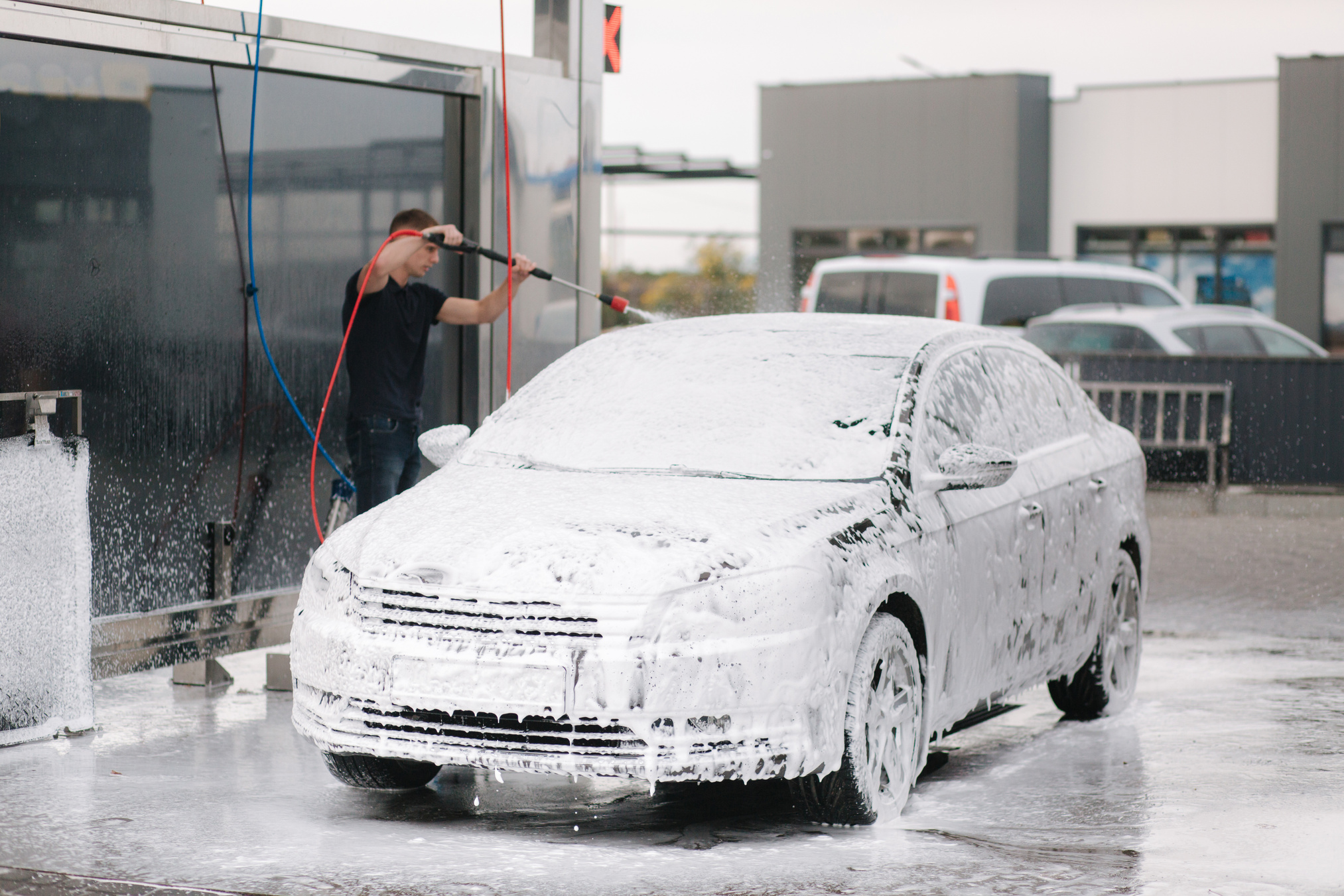Man Washing His Car with Active Foam 
